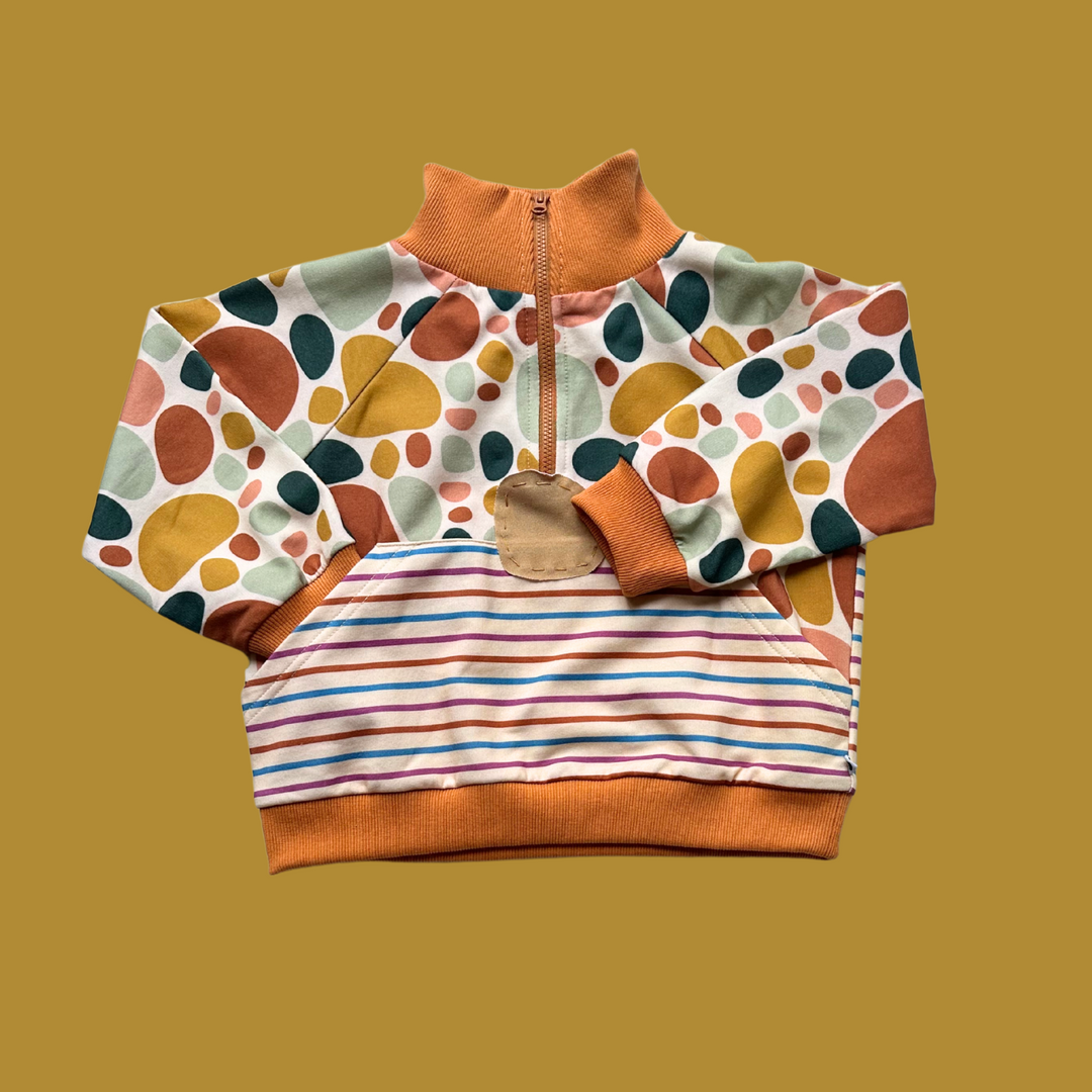 More The Label organic cotton children's clothing Stone Print Jumper flat lay image of front. Features exclusive stone print and custom stripe print. YKK zip opening and hand stitched stone detail.