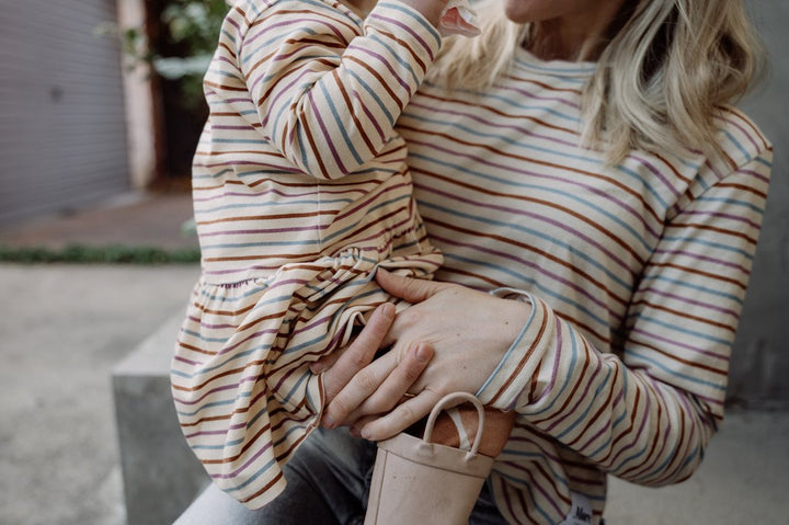 Close up image of More the label Owner and designer Kate, wearing More the label striped long sleeve tee and child wearing striped skater dress with stone print leggings and gumboots.