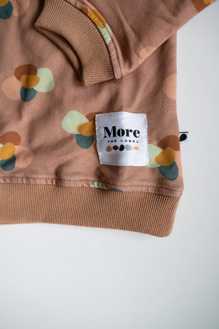 Close up image of More the label logo patch on stone huddle jumper.