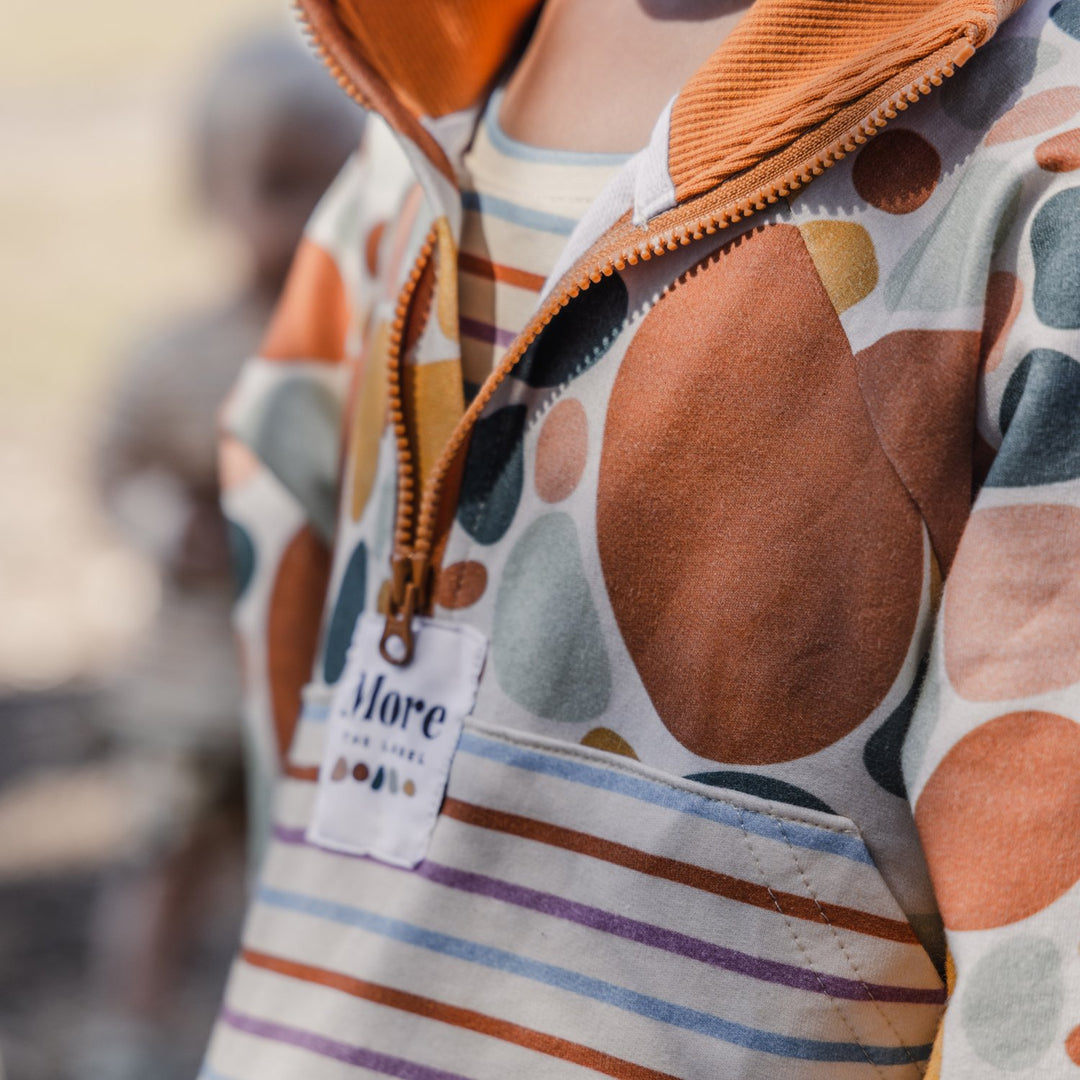 More The Label organic cotton children's clothing Stone Print Jumper close up image. Features exclusive stone print and custom stripe print. YKK zip opening and hand stitched stone detail. 
