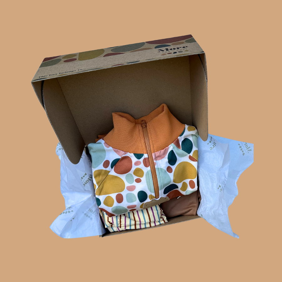 Flat lay image of stone print gift box with Stone Print Pullover in it. A keepsake for your little one’s most treasured collections. Made from eco-friendly kraft cardboard and adorned with our signature stone print and subtle More The Label branding.