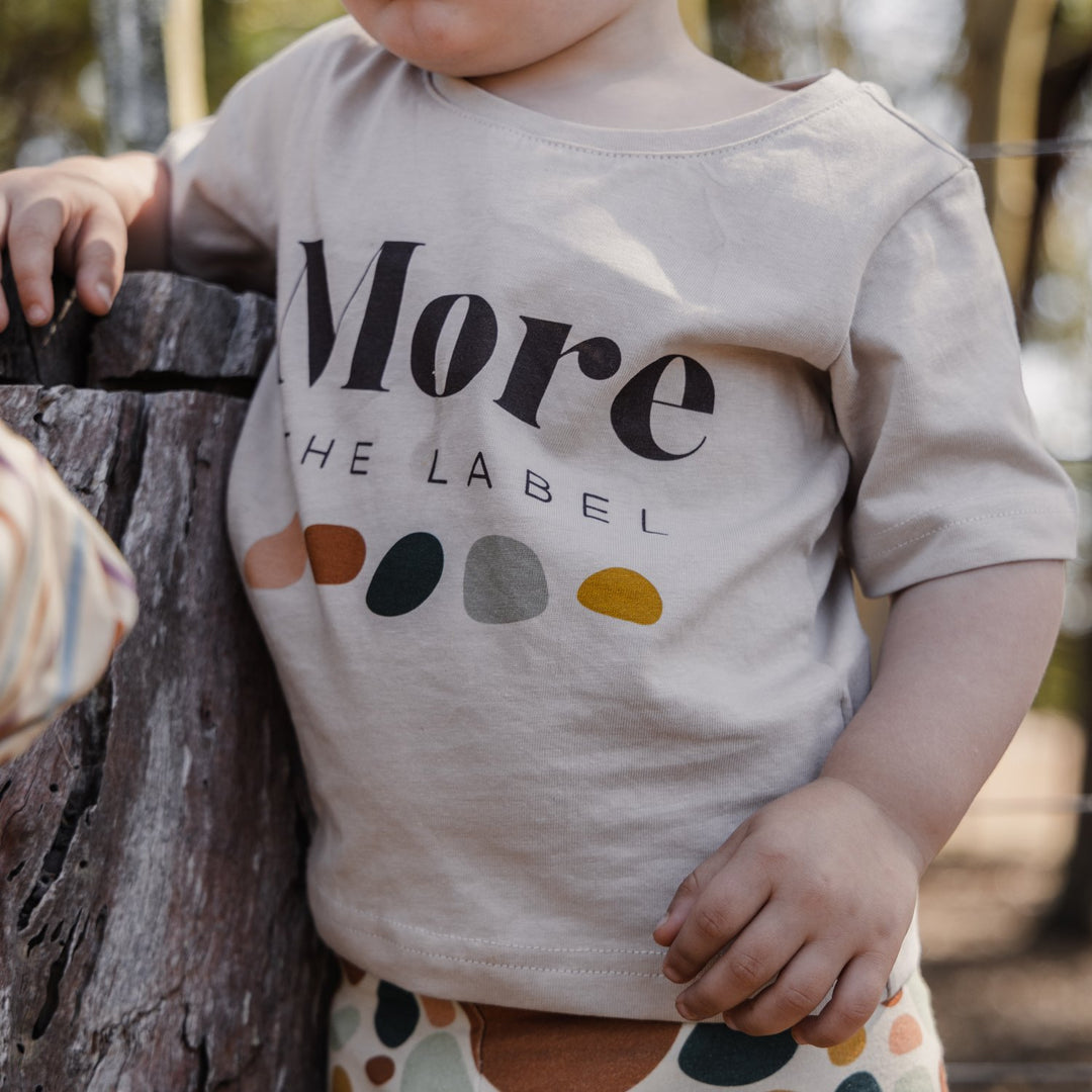 Close up image of two year old child wearing More the label logo tee.